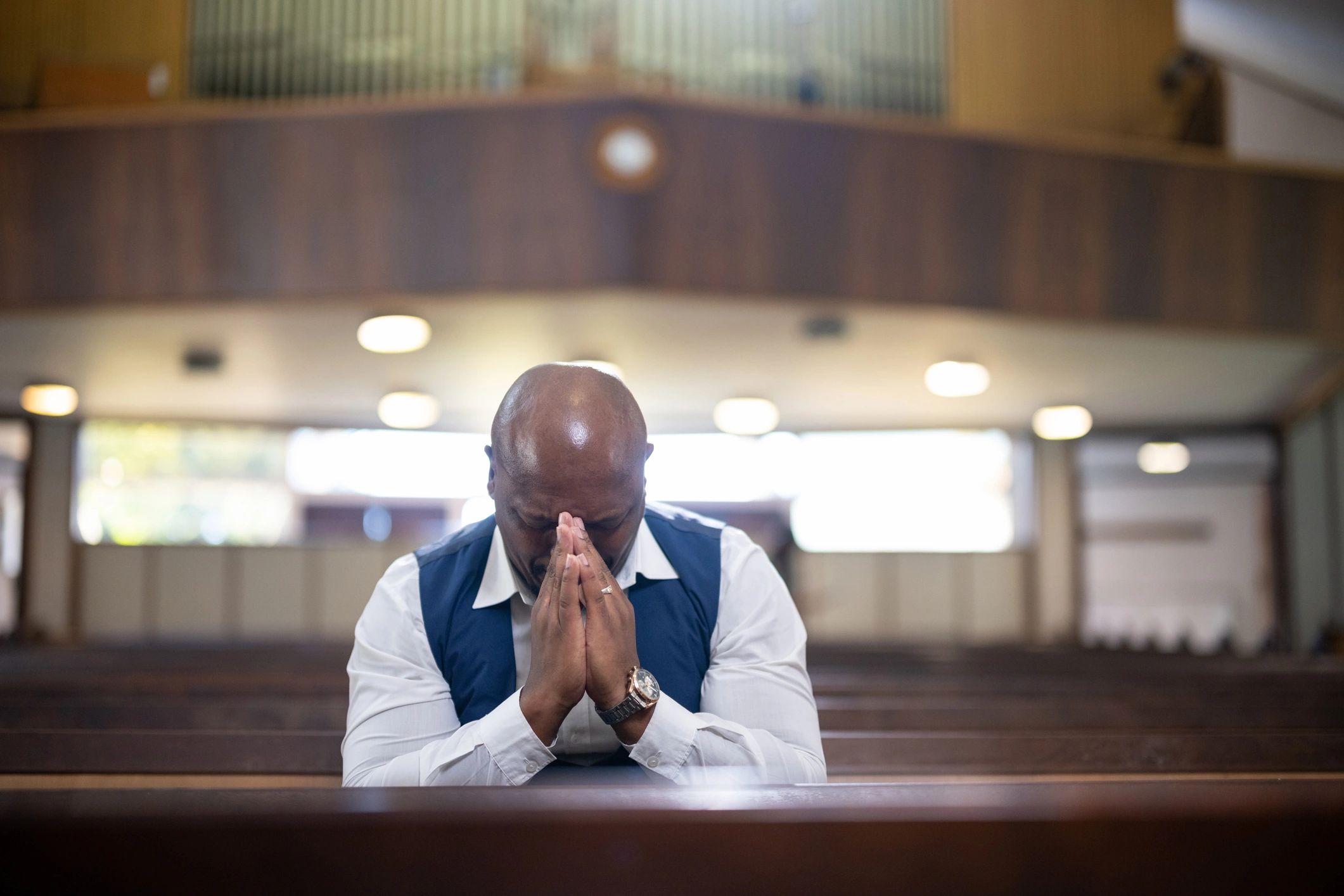 Person praying in a church pew